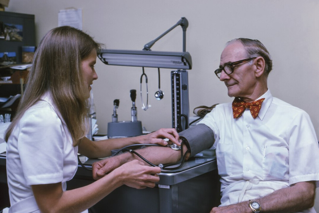 Nurse checking blood pressure of an elderly patient